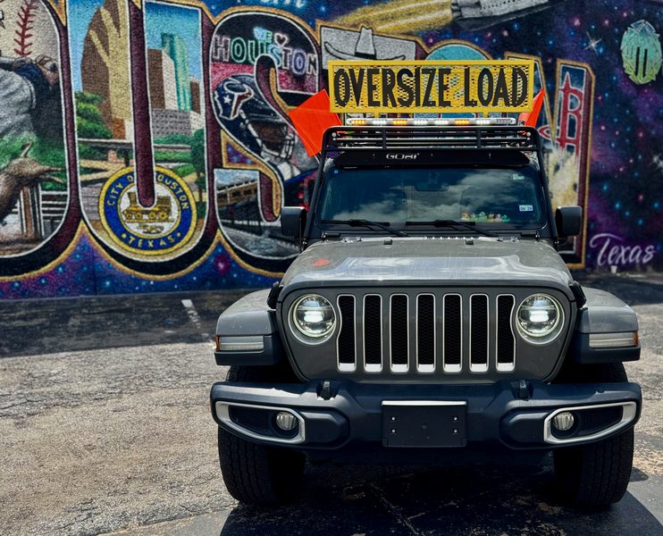 Pilot car front view with OVERSIZE LOAD sign and Houston mural